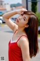 A woman in a red dress posing for a picture.